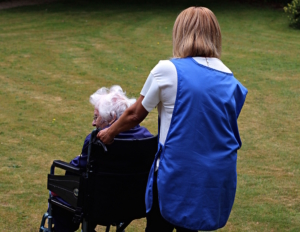 Old lady in wheelchair with carer