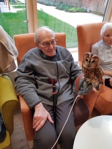 Holding an owl during a visit from Al's owls