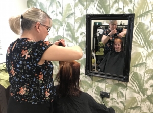 Carer Pat hair cut Carer has her hair cut at Fairfield's Carers Day